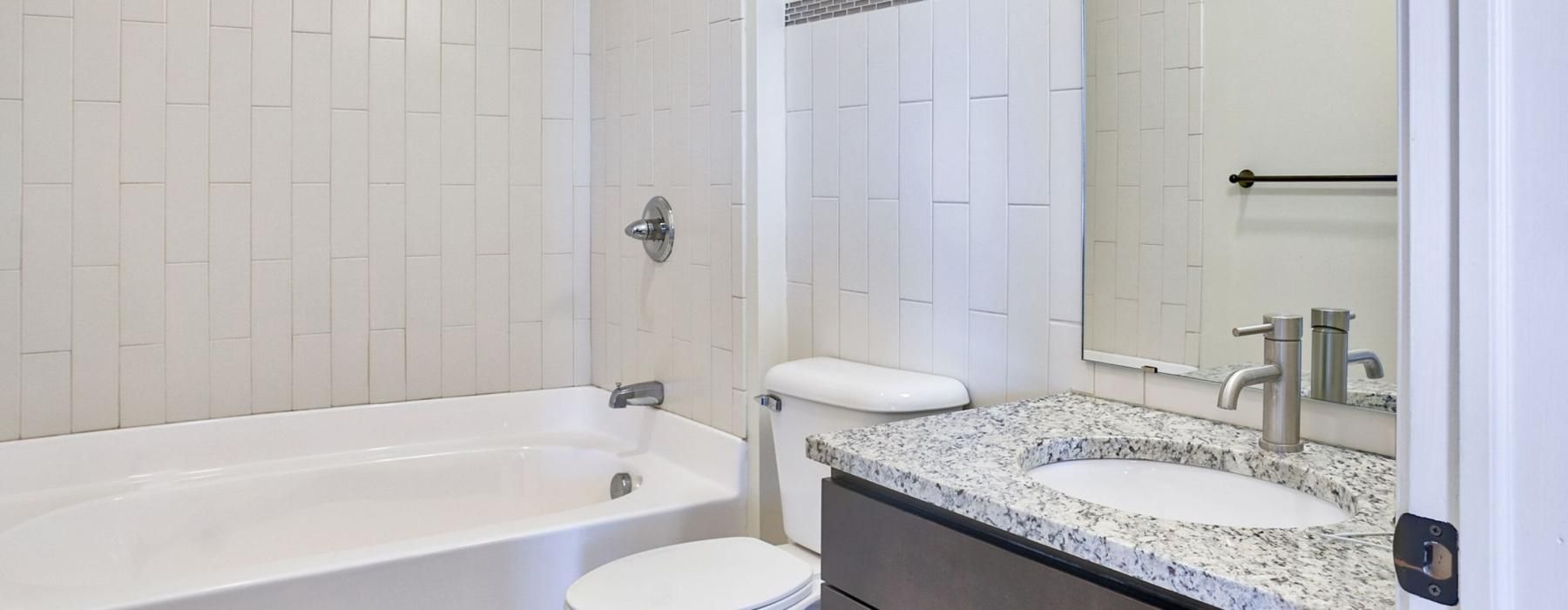 a bathroom with a tub sink and toilet