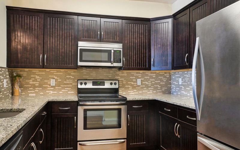 a kitchen with black cabinets